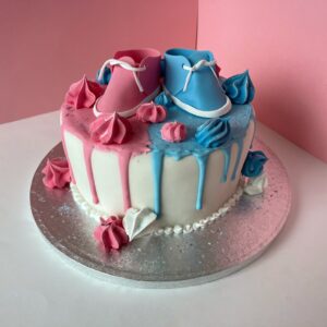 gender reveal cake with baby shoes